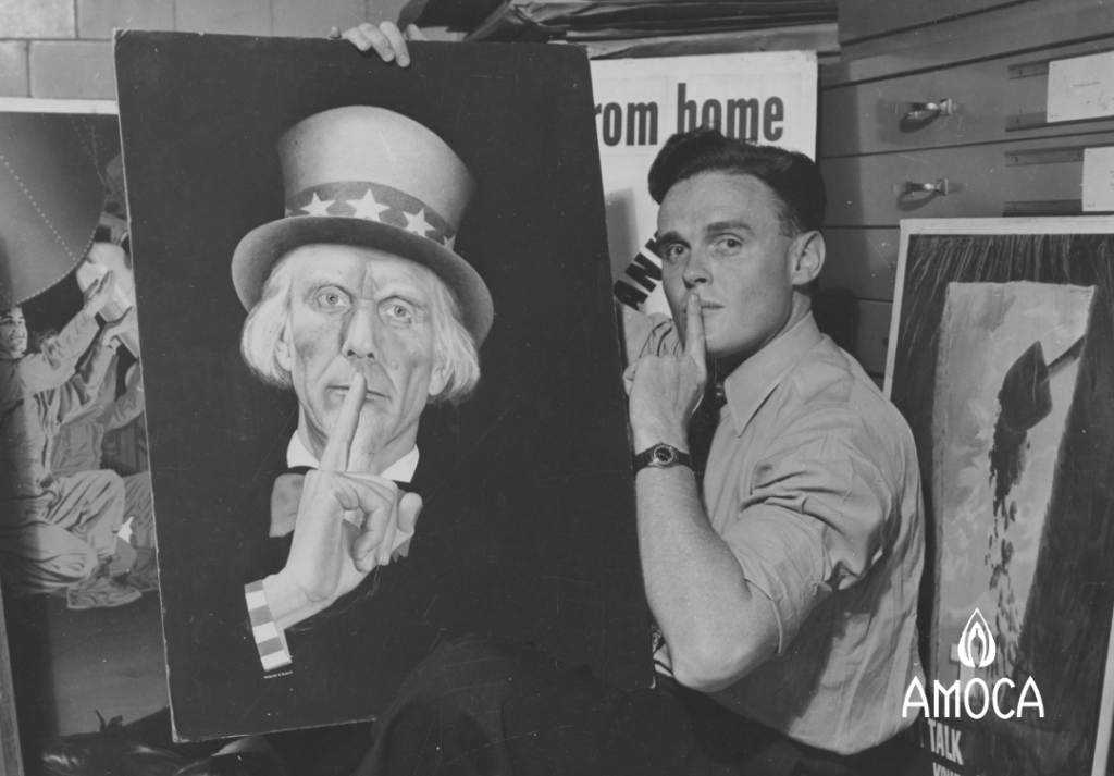 a man with his index finger at his mouth holding a painted image of Uncle Sam with finger to his mouth.