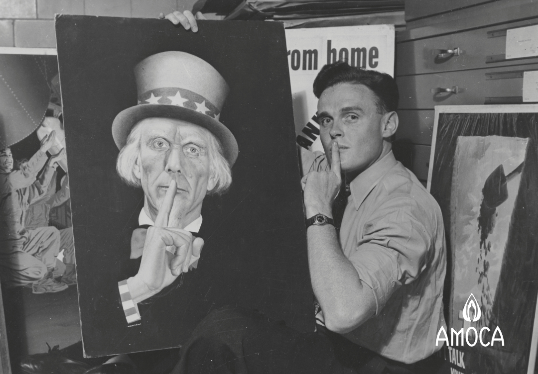 a man with his index finger at his mouth holding a painted image of Uncle Sam with finger to his mouth.